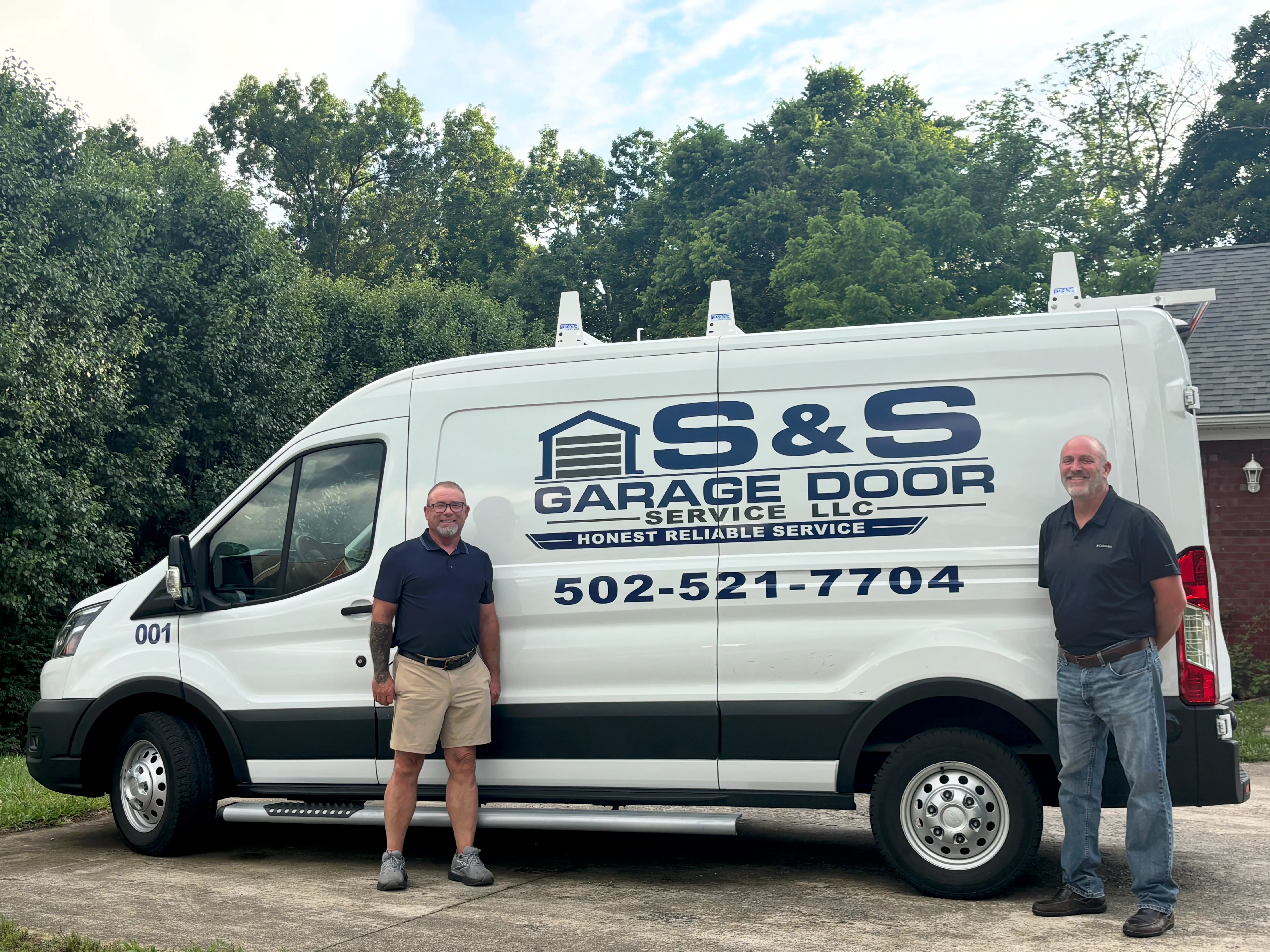 Kurt Spalding and Todd Sanders standing beside the S & S Garage Door Service, LLC service truck